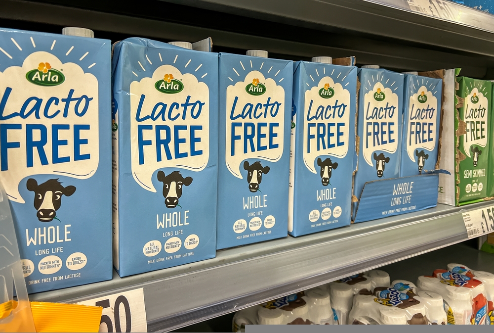 Arla lacto free milk displayed on the shelves in a supermarket. Arla Foods Ltd is a major dairy products company in the United Kingdom.