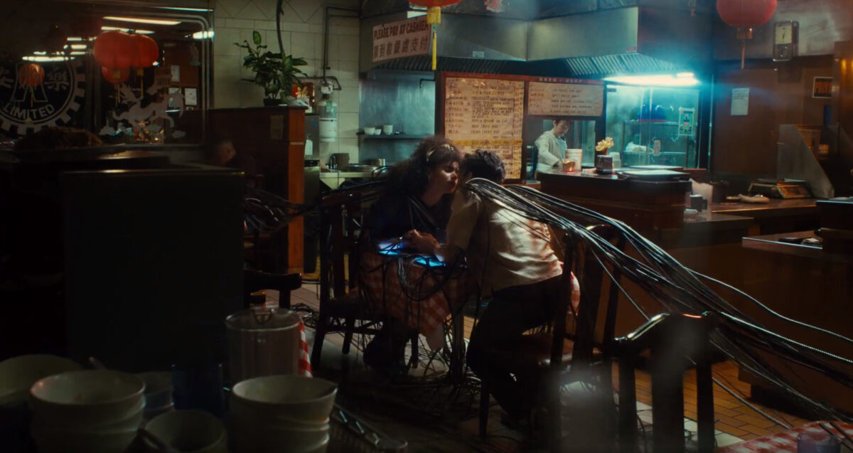 Screenshot of ExxonMobil campaign showing a couple trying to kiss but are trapped in heavy cables