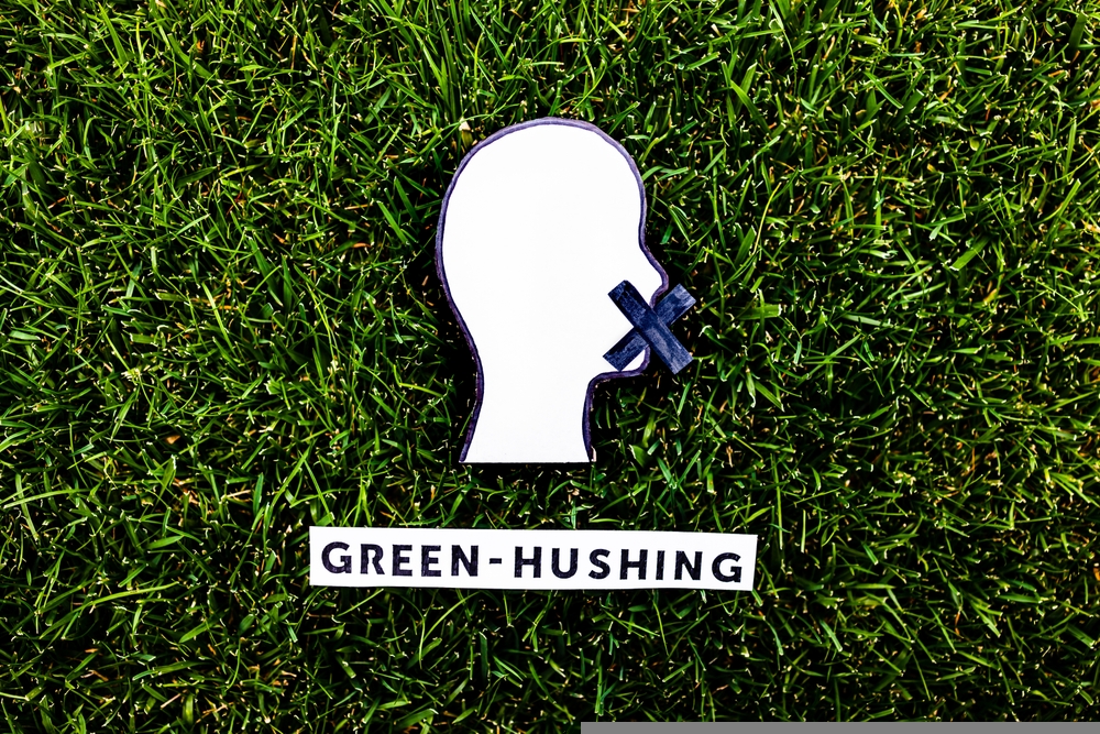 greenhushing concept about companies staying silent about their environmental footprints and policies, text and face with mouth shut on green grass