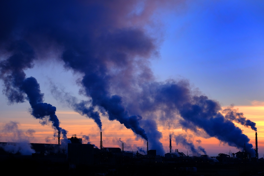 Pollution smoke from a factory plan in the air. Over 1,200 scientists are calling for the Royal Society to make an “unambiguous statement” about the fossil fuel industry’s role in the climate crisis.