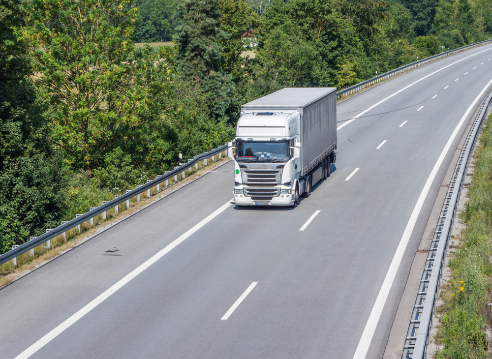 White HGV truck driving on the asphalt road - Zero emission trucks are exempt from the reintroduced HGV levy, which was reintroduced yesterday after a break due to the pandemic.