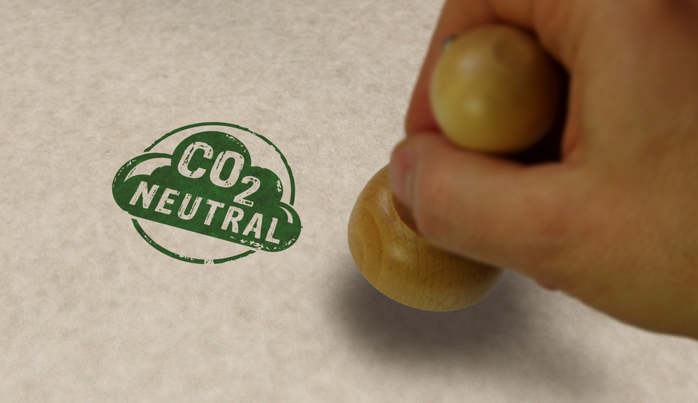 CO2 carbon neutral emission stamp and stamping hand. Ecology, nature friendly, climate change, green fuel and earth protect concept.