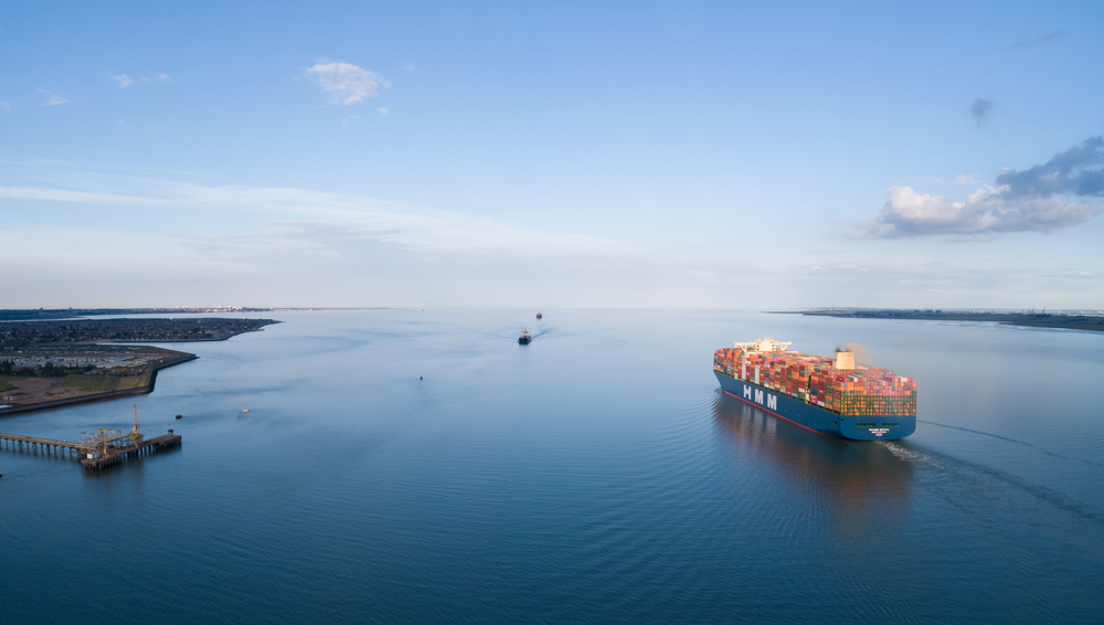 The BIGGEST container ship in the world, the HMM Algeciras leaving the DP World Gateway Port passing Canvey Island, Essex, United Kingdom shipping