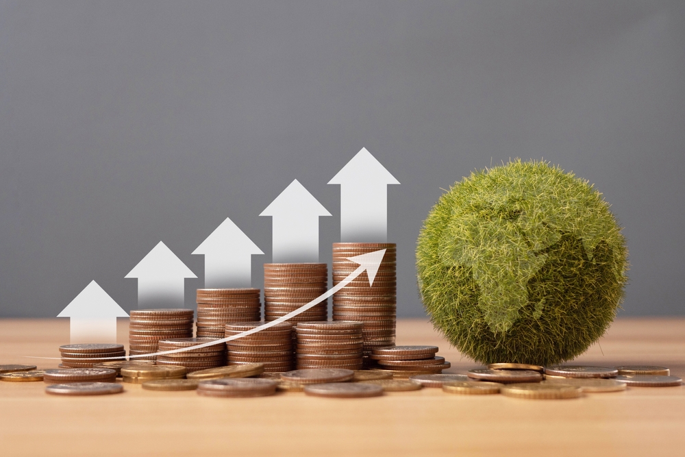 Growth money arrow with stack of silver coins and green earth. Concept of climate finance and sustainability investment.