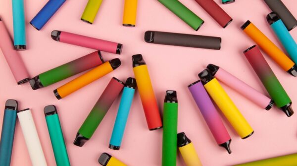 Disposable e-cigarettes with different flavors in pink. The concept of modern smoking, vaping and nicotine. The UK Vaping Industry Association (UKVIA) is urging retailers and consumers to recycle vapes in a Sustainable Vaping Week campaign.