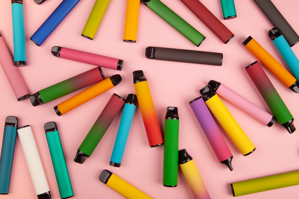 Disposable e-cigarettes with different flavors in pink. The concept of modern smoking, vaping and nicotine. The UK Vaping Industry Association (UKVIA) is urging retailers and consumers to recycle vapes in a Sustainable Vaping Week campaign.