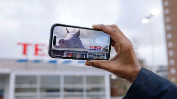 A giant, virtual, female pig appears on top Tesco store in a campaign against deforestation