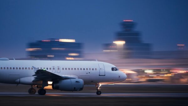 Airplane during take off on airport runway at night against air traffic control tower. Plane in blurred motion at night. Campaigners have released an open letter stating they’re “deeply concerned” about the Science Based Targets initiative (SBTi)’s work on aviation.