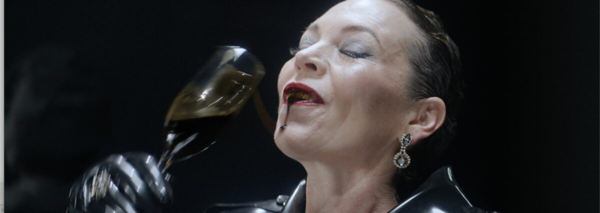 Olivia Colman with oil spills a champagne glass of oil down herself as part of anti fossil fuel campaign for MakeMyMoneyMatter