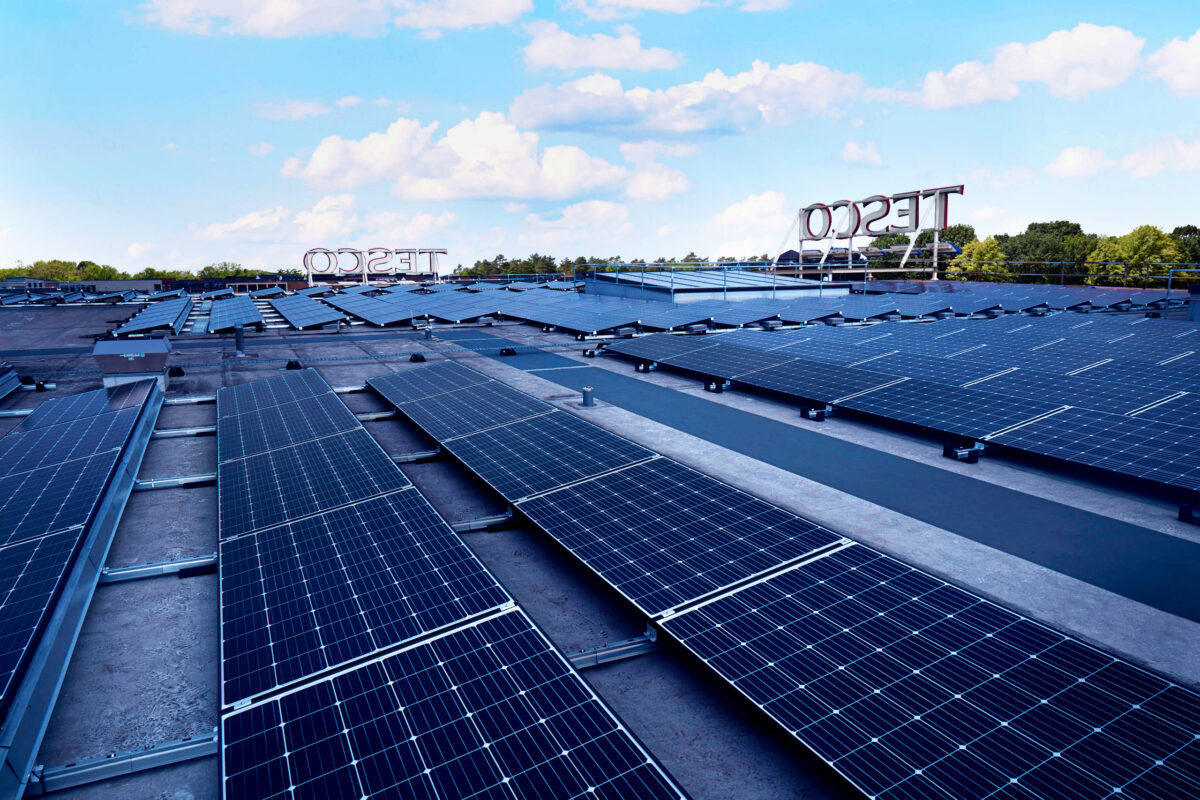 Solar panels above a Tesco store.Tesco plans to install solar panels on over 100 of its large stores across the UK within the next three years.