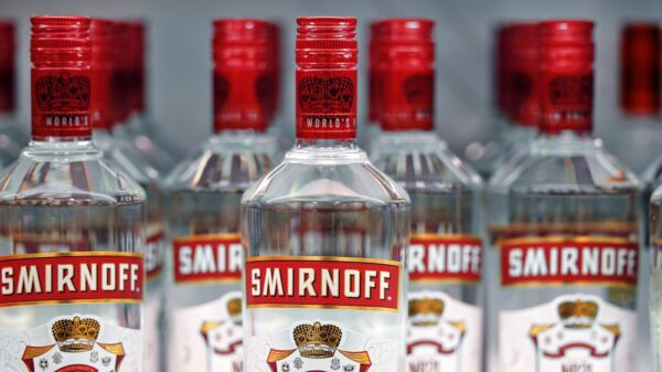 Diageo' Bottles of Smirnoff vodka on a shelf in duty free shop in Dubai Airport. Traditional Russian souvenir.