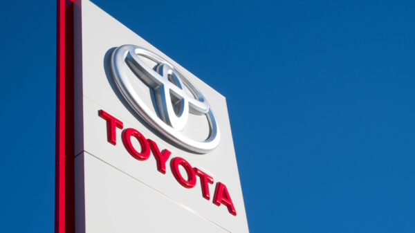 Toyota dealership sign against blue sky.