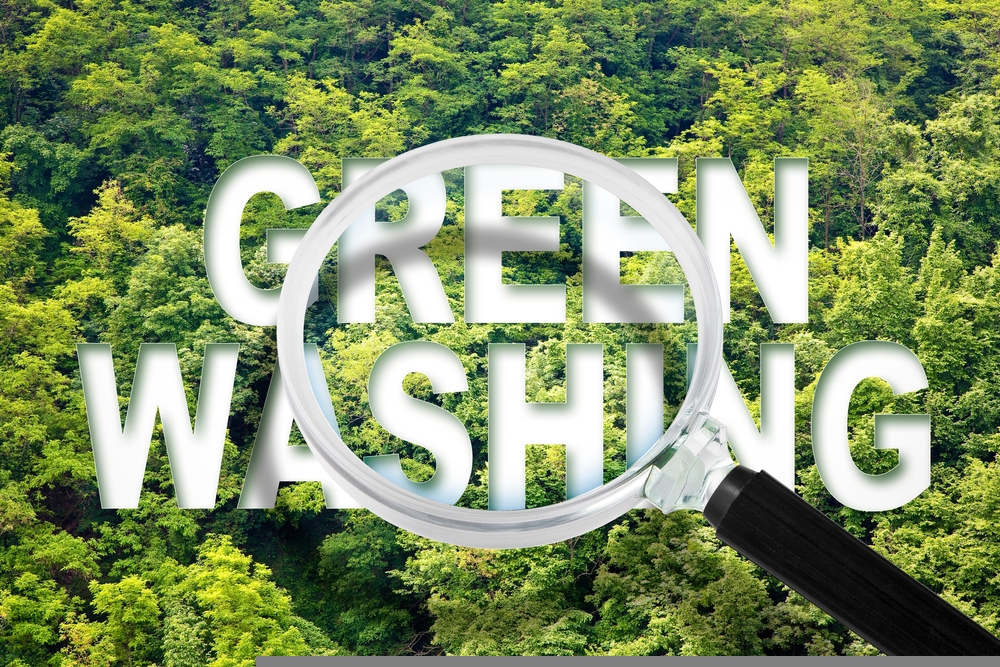 Greenwashing - concept with text against a forest and trees and magnifying glass. ASA chief executive Guy Parker has claimed that AI tools could help counteract the increased use of unverified climate buzzwords for products.