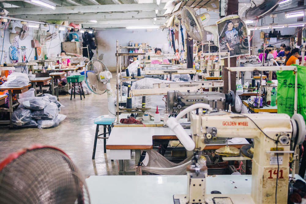 Burmese Female Migrant Workers Sewing or Stitching Leather Shoes in footwear production line of factory in Sankhlaburi, Kanchanaburi, Myanmar border province