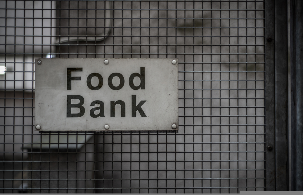 A Grungy Sign For A Food Bank In A Backstreet. Research by the Nuffield Foundation found that the poorest 40% of households are at risk of falling into “transition poverty” due to net zero policies.