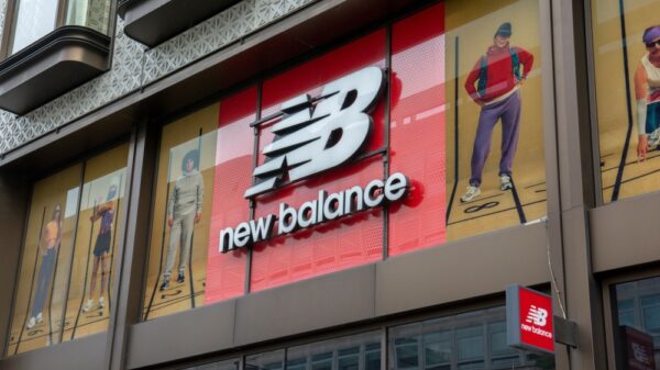 New Balance retail store and brand logo. New Balance, is one of the world's major sports footwear and apparel manufacturers.