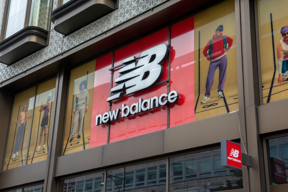 New Balance retail store and brand logo. New Balance, is one of the world's major sports footwear and apparel manufacturers.