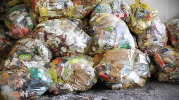 Keep Britain Tidy bins ‘reduce, reuse, recycle’ messaging View of bagged waste on a city centre street