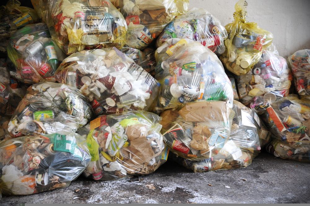 Keep Britain Tidy bins ‘reduce, reuse, recycle’ messaging View of bagged waste on a city centre street