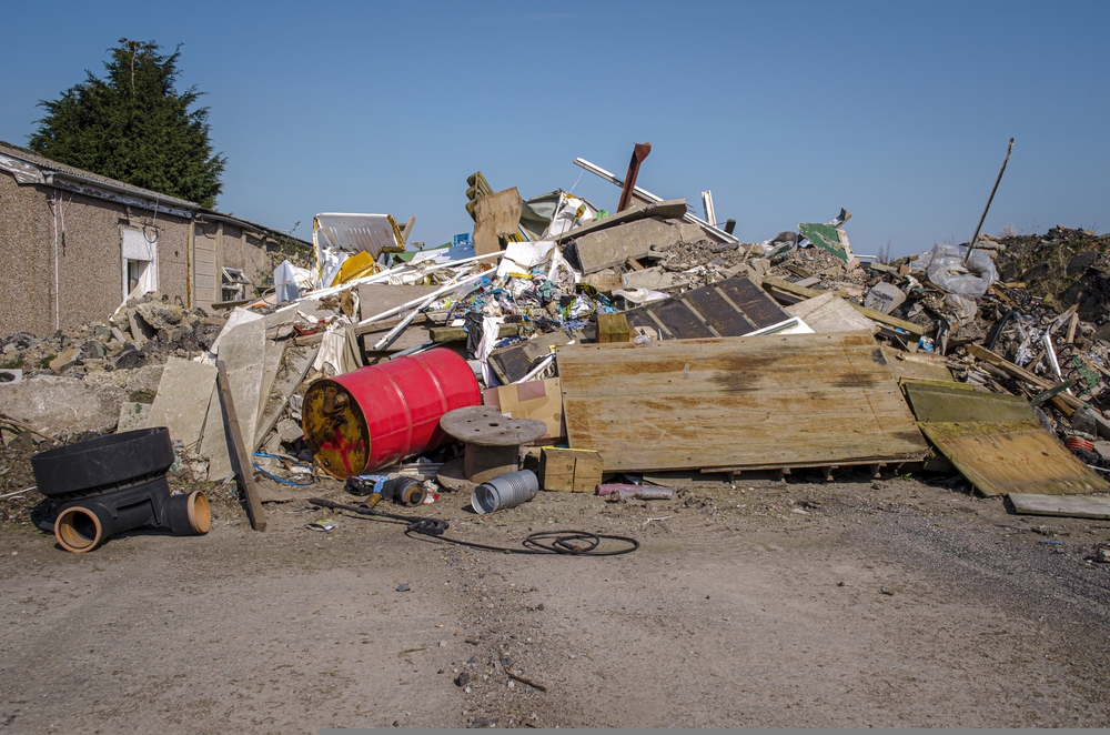 Mounds of demolition rubble and industrial waste at abandoned industrial site. The Environment agency has launched the Economic Crime Unit to tackle money laundering in the waste sector.