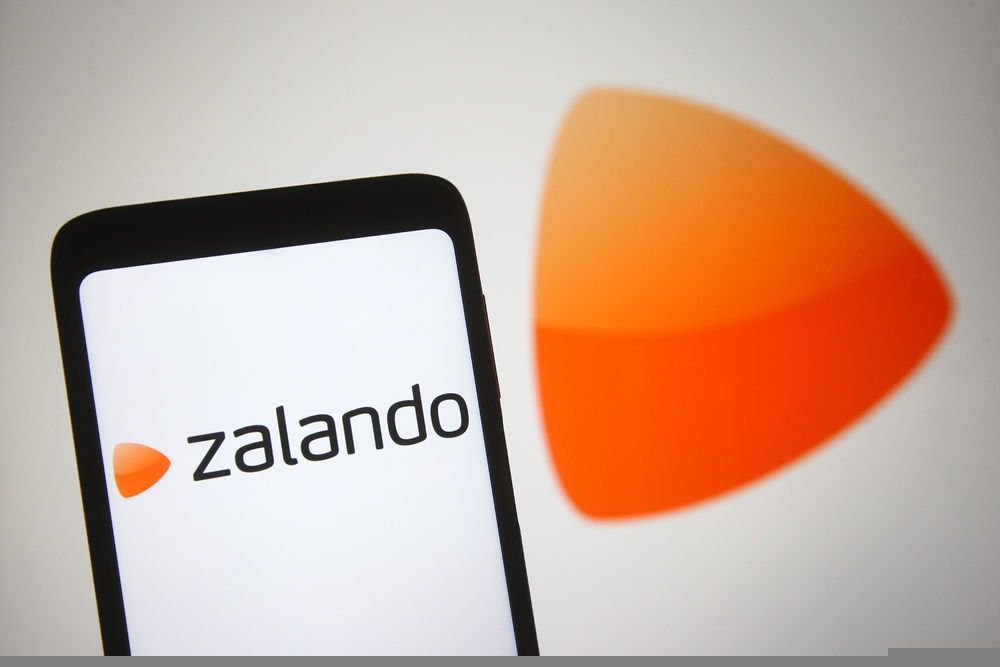 In this photo illustration Zalando SE logo of a European e-commerce company is seen on a mobile phone and a computer screen.